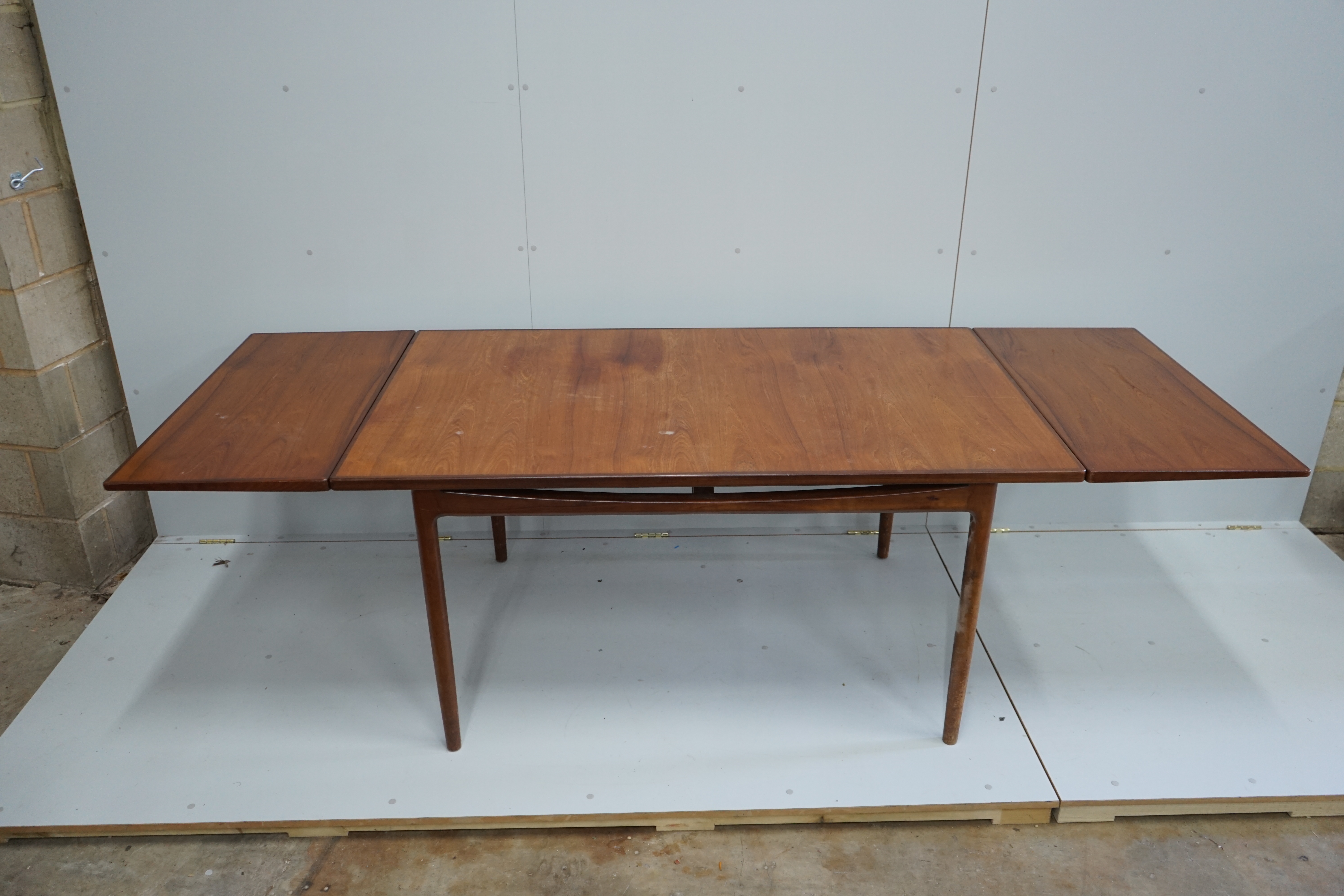Henning Kjaernulf for Bruno Hansen, four Model 225 'Wishbone' teak dining chairs, width 55cm, depth 44cm, height 64cm and a rectangular extending teak dining table, 244cm extended, width 89cm, height 72cm
